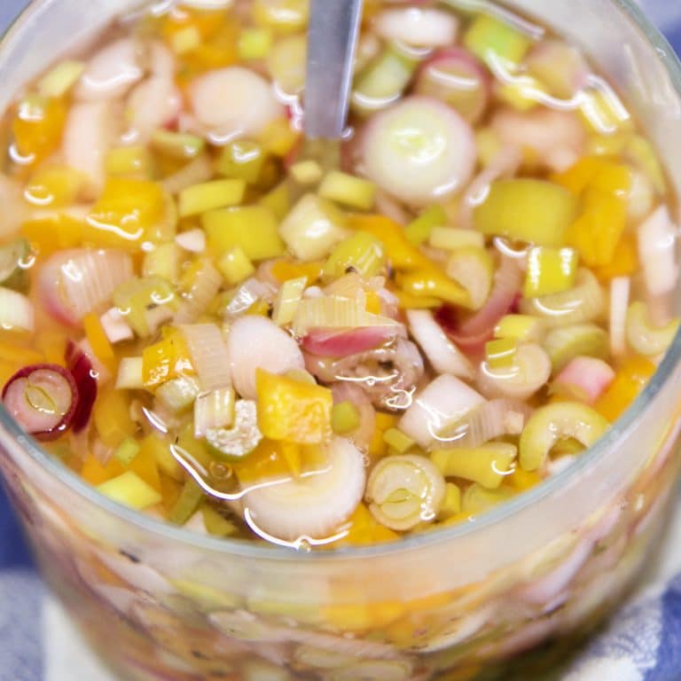 Pickled Green Onion relish in a jar with spoon.