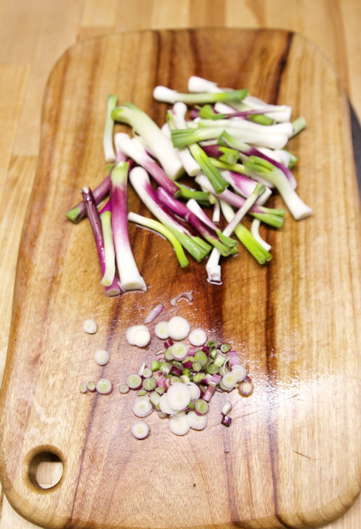 Scallions on a cutting board.
