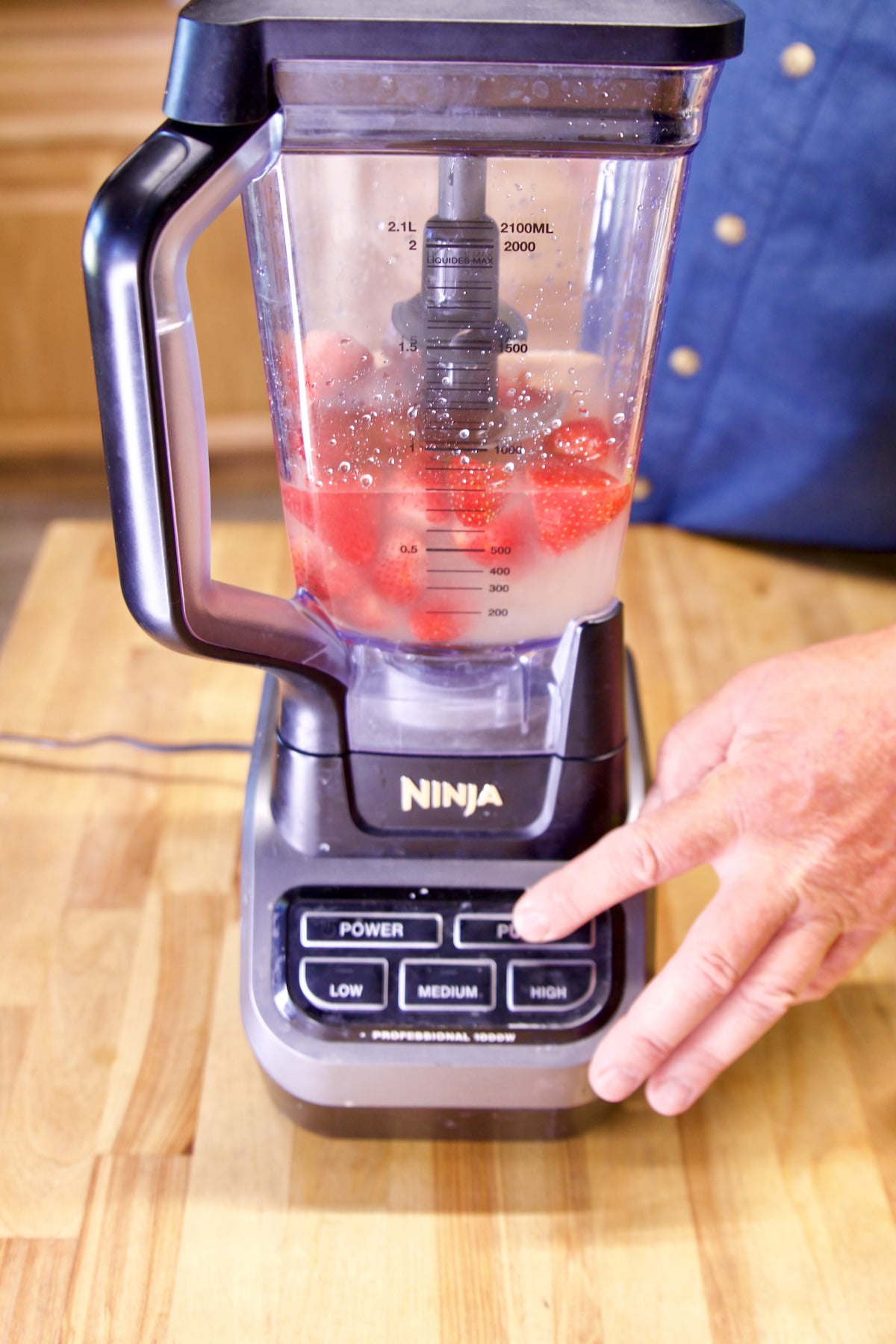 Blending strawberry lemonade cocktails.