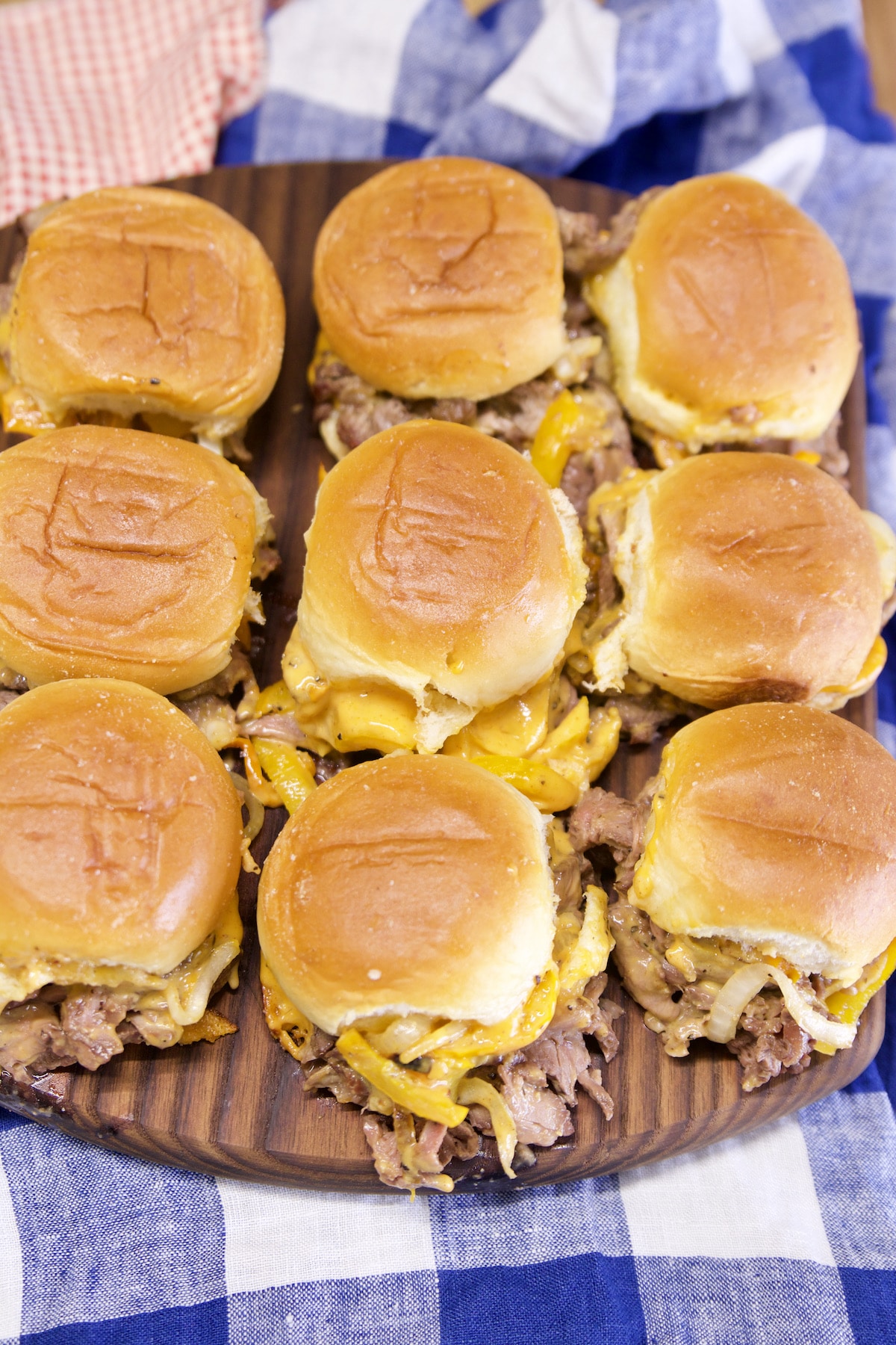 Cheesesteak Sliders on a cutting board.