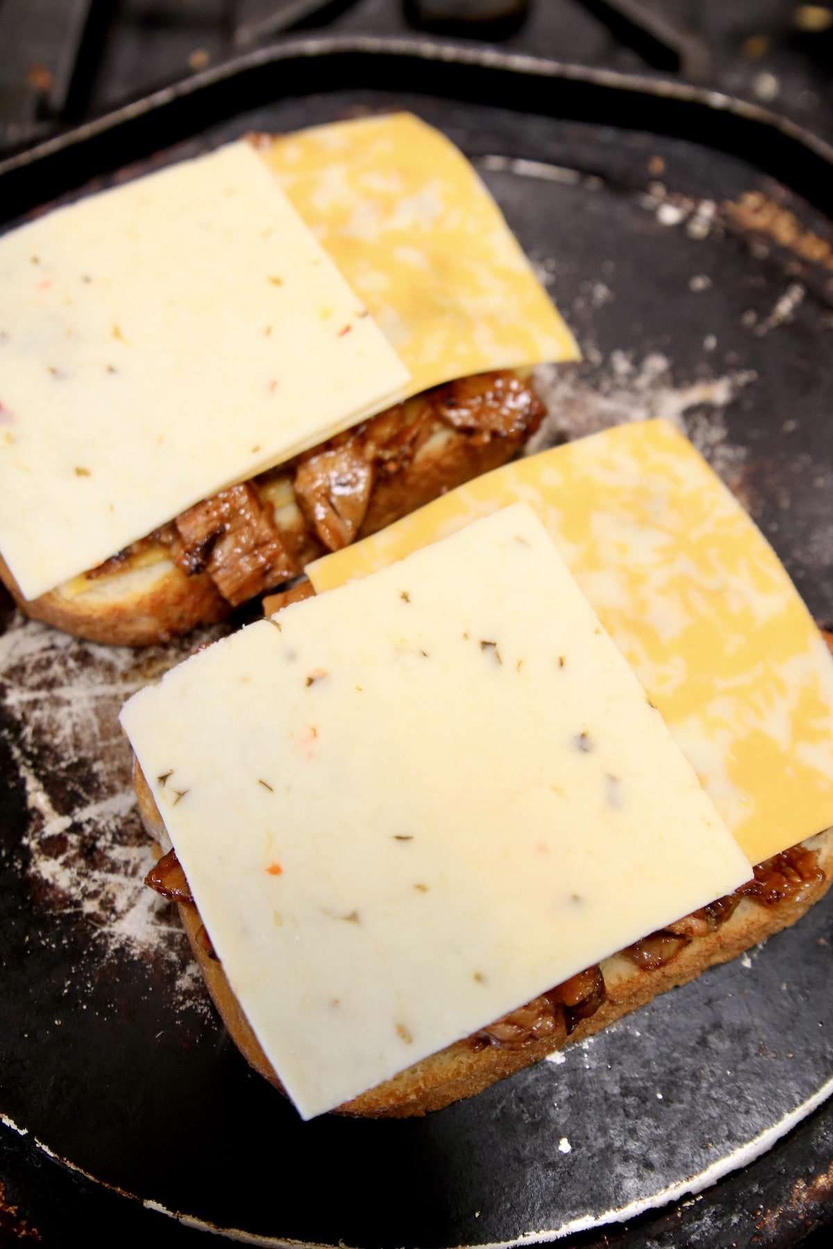 Making grilled cheese with brisket and cheese.
