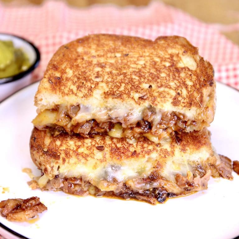 Brisket Grilled Cheese, cut in half stacked.