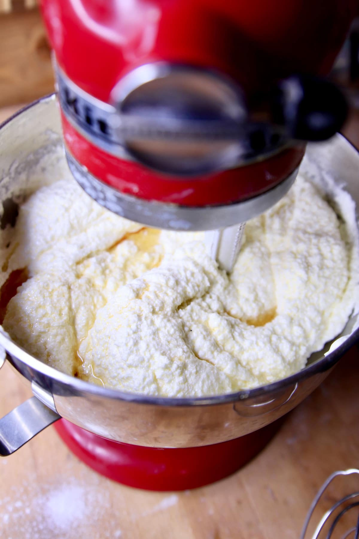 Vanilla added to cake batter in mixer bowl.