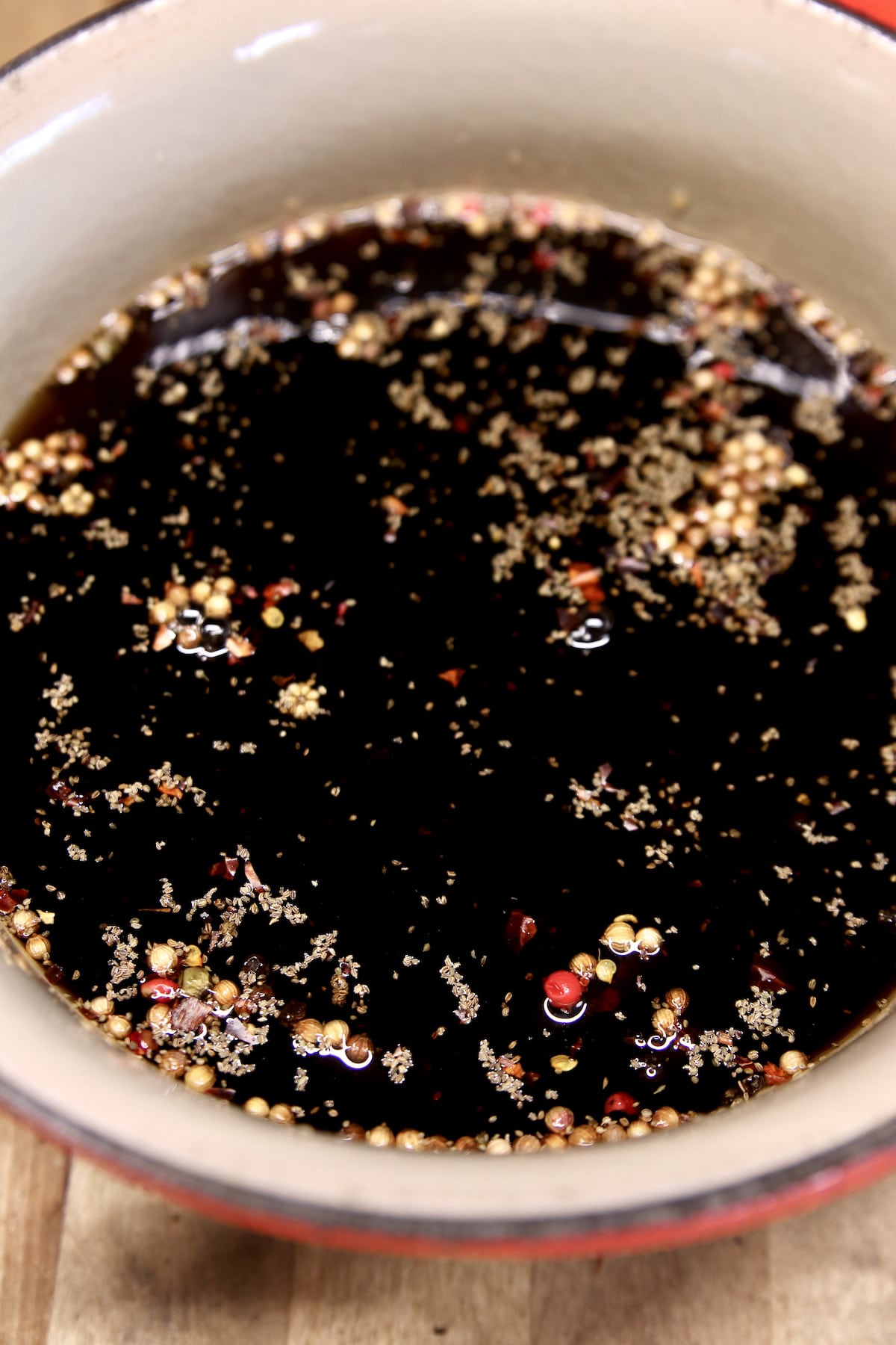 malt vinegar and pickling spices in a pan.