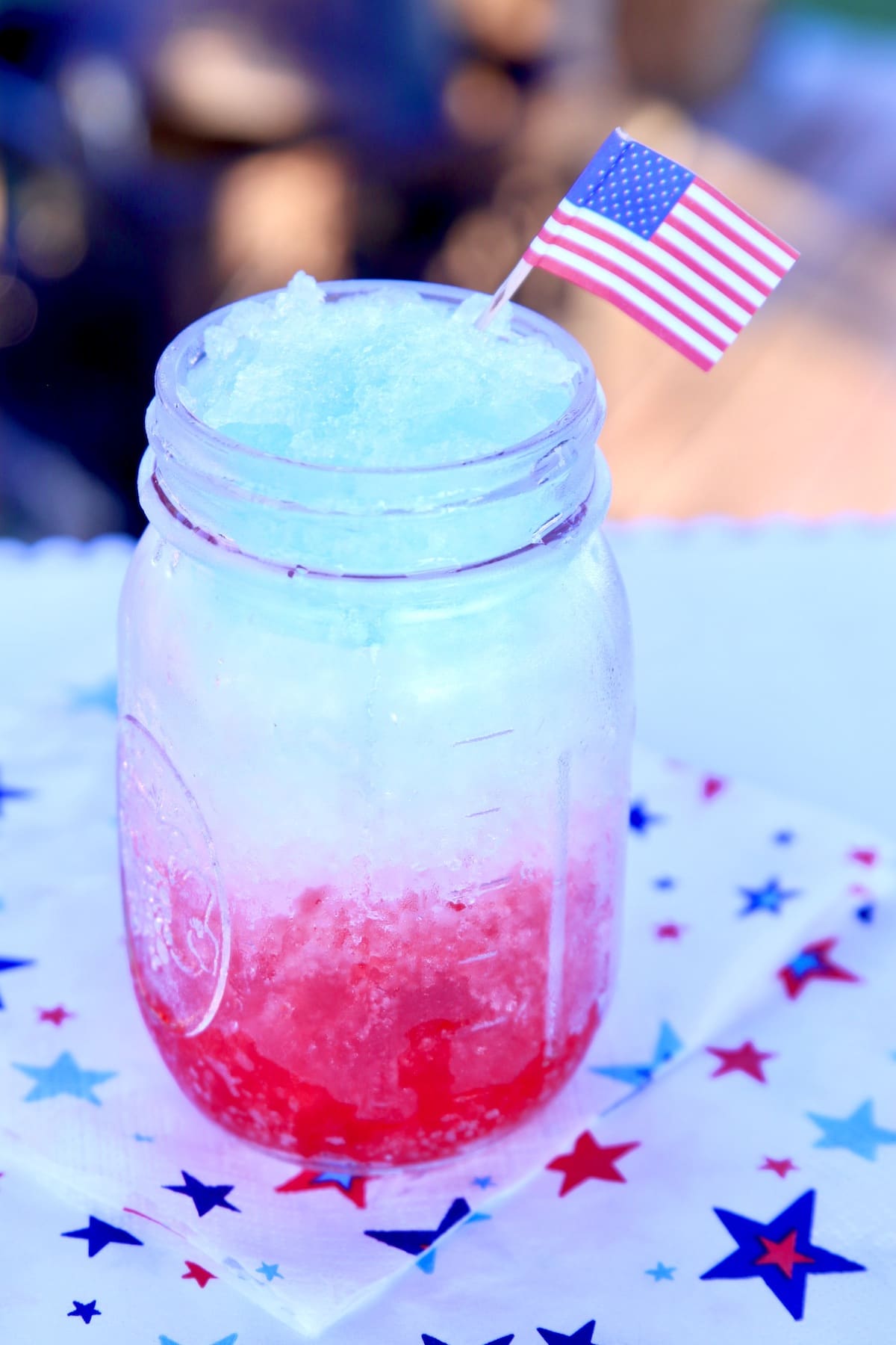 Mason jar with red white and blue slush.