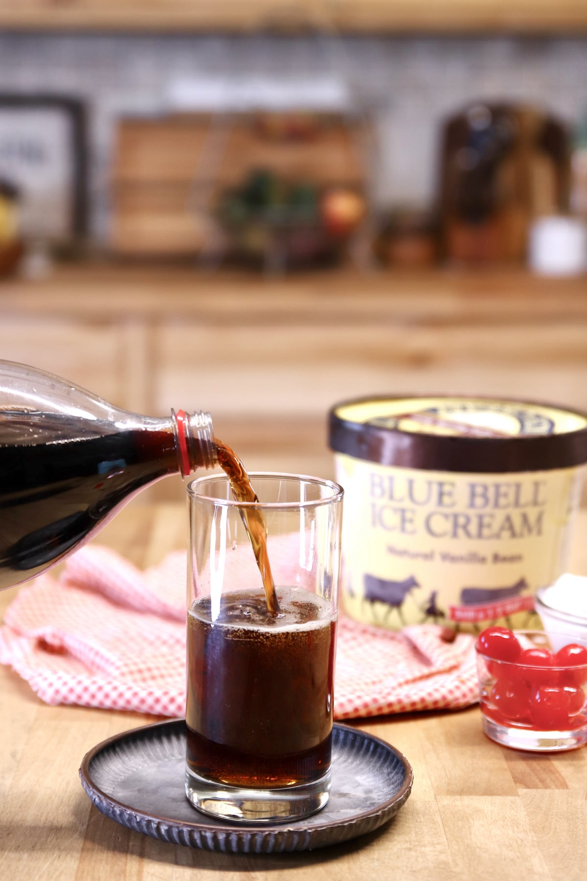 Filling a glass with Coke.