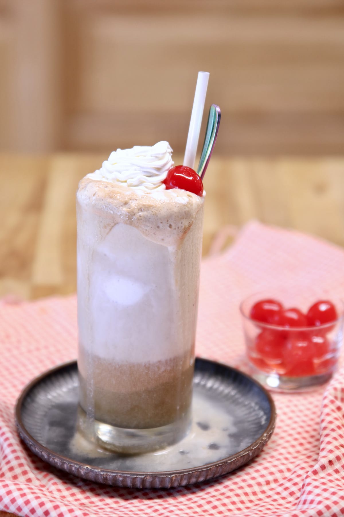 Rum and Coke float with cherry on top.