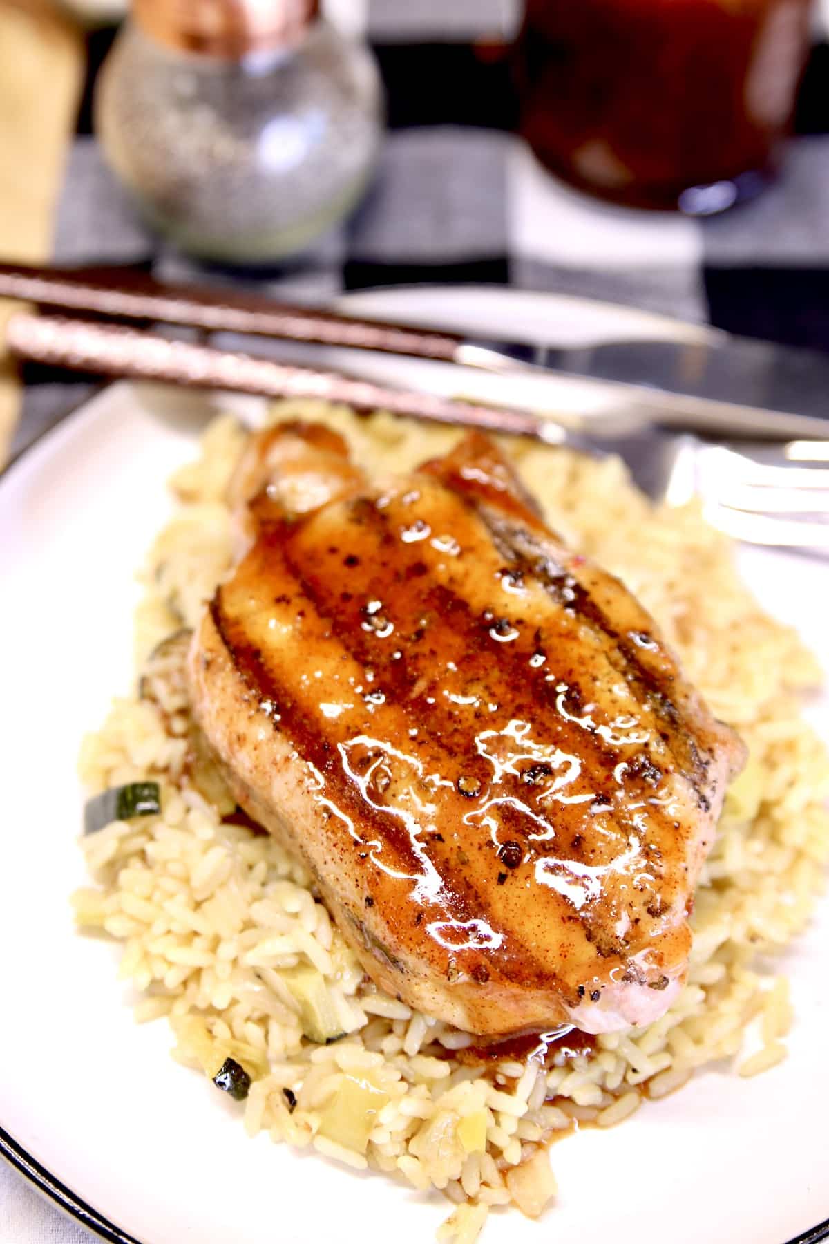 Plated pork chop with honey garlic sauce.