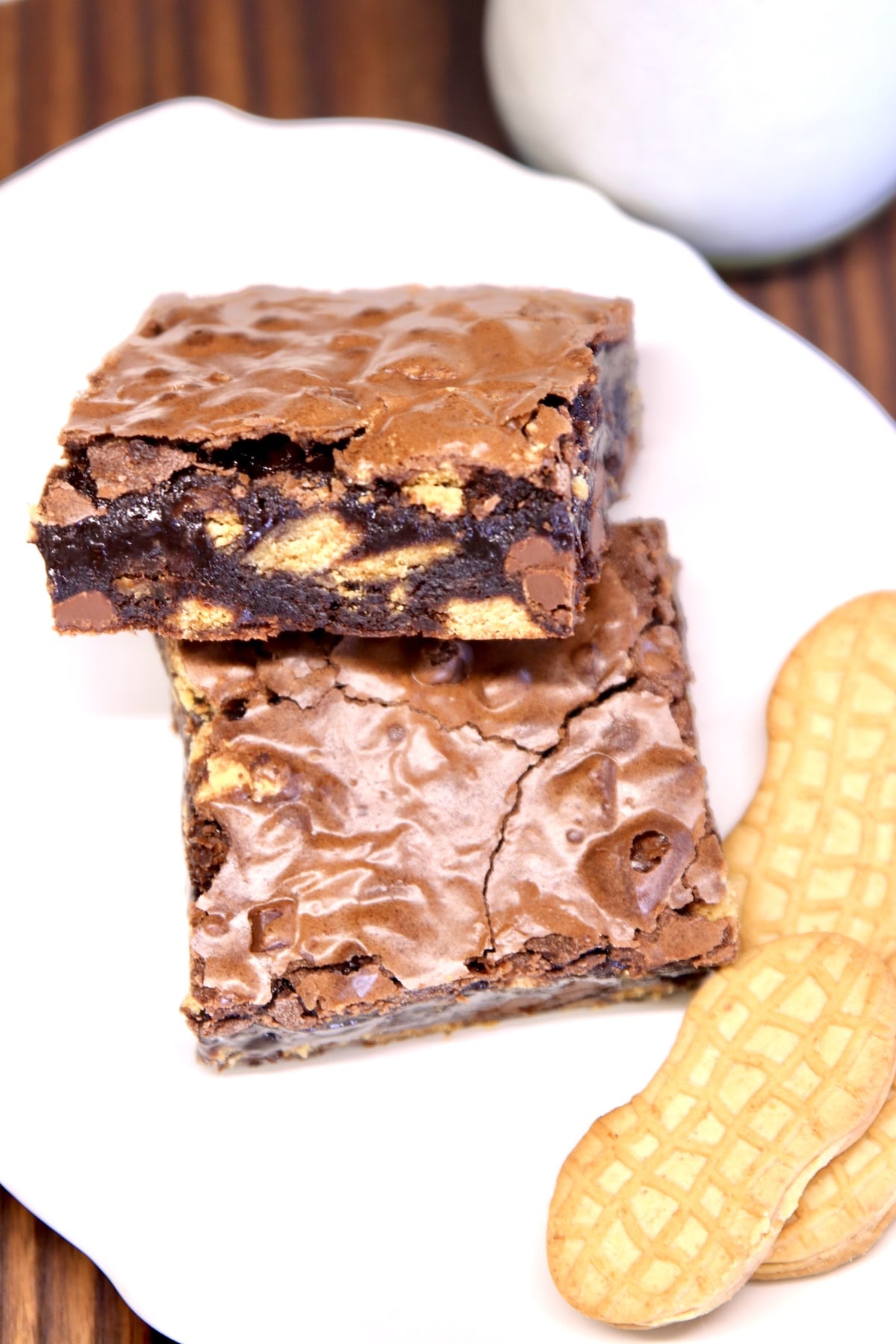 2 brownies on a plate with Nutter Butter cookies.
