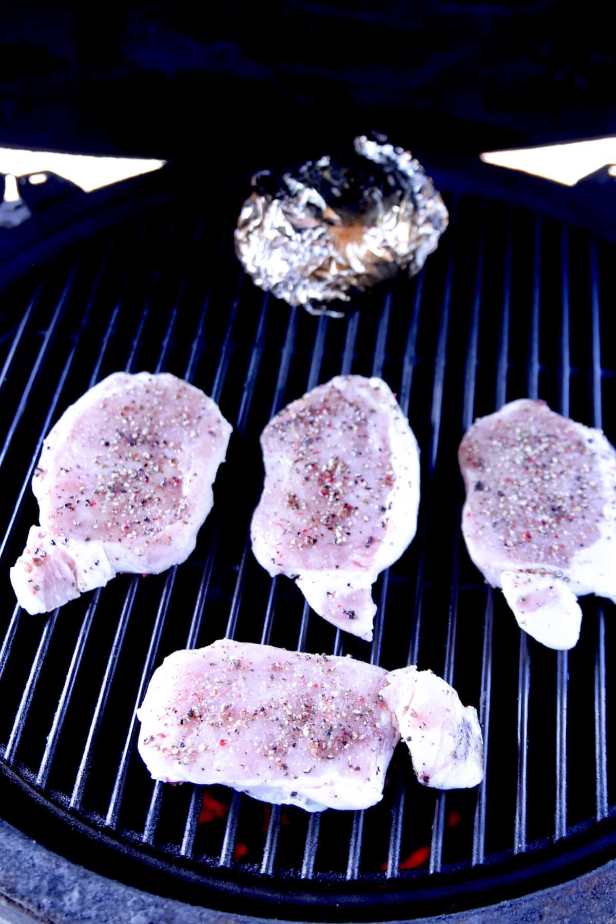 4 Boneless pork chops on a grill.