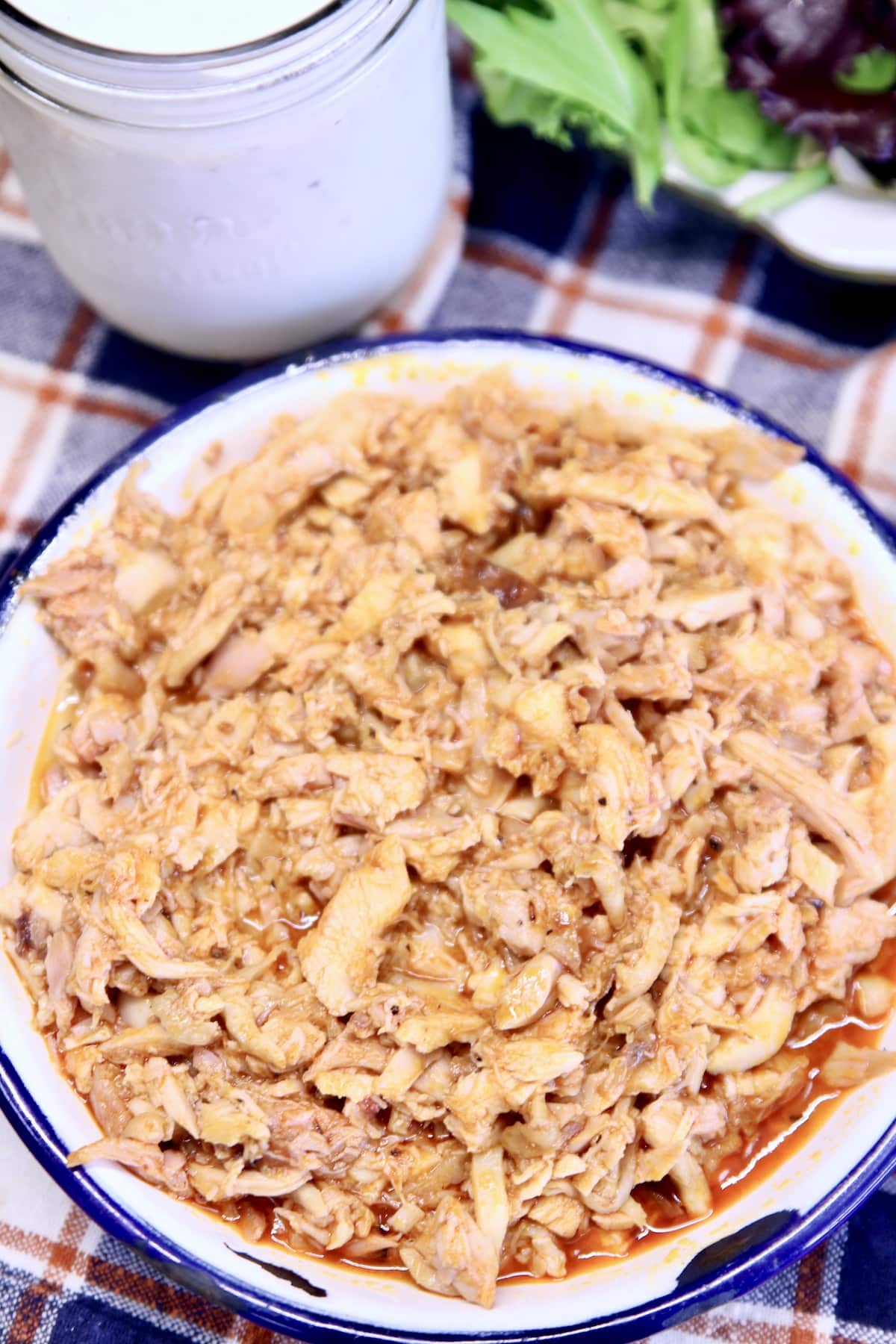 Bowl of hot honey chicken, shredded.