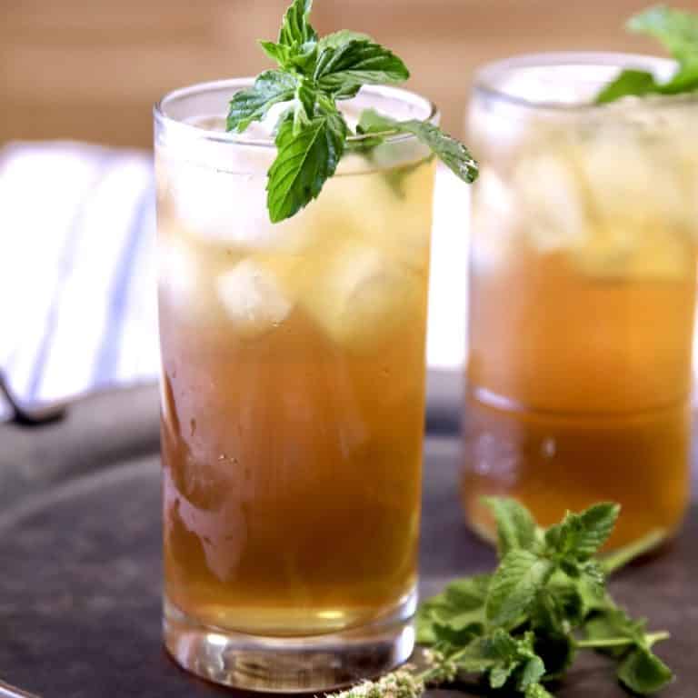 2 glasses of tea with fresh mint garnish.