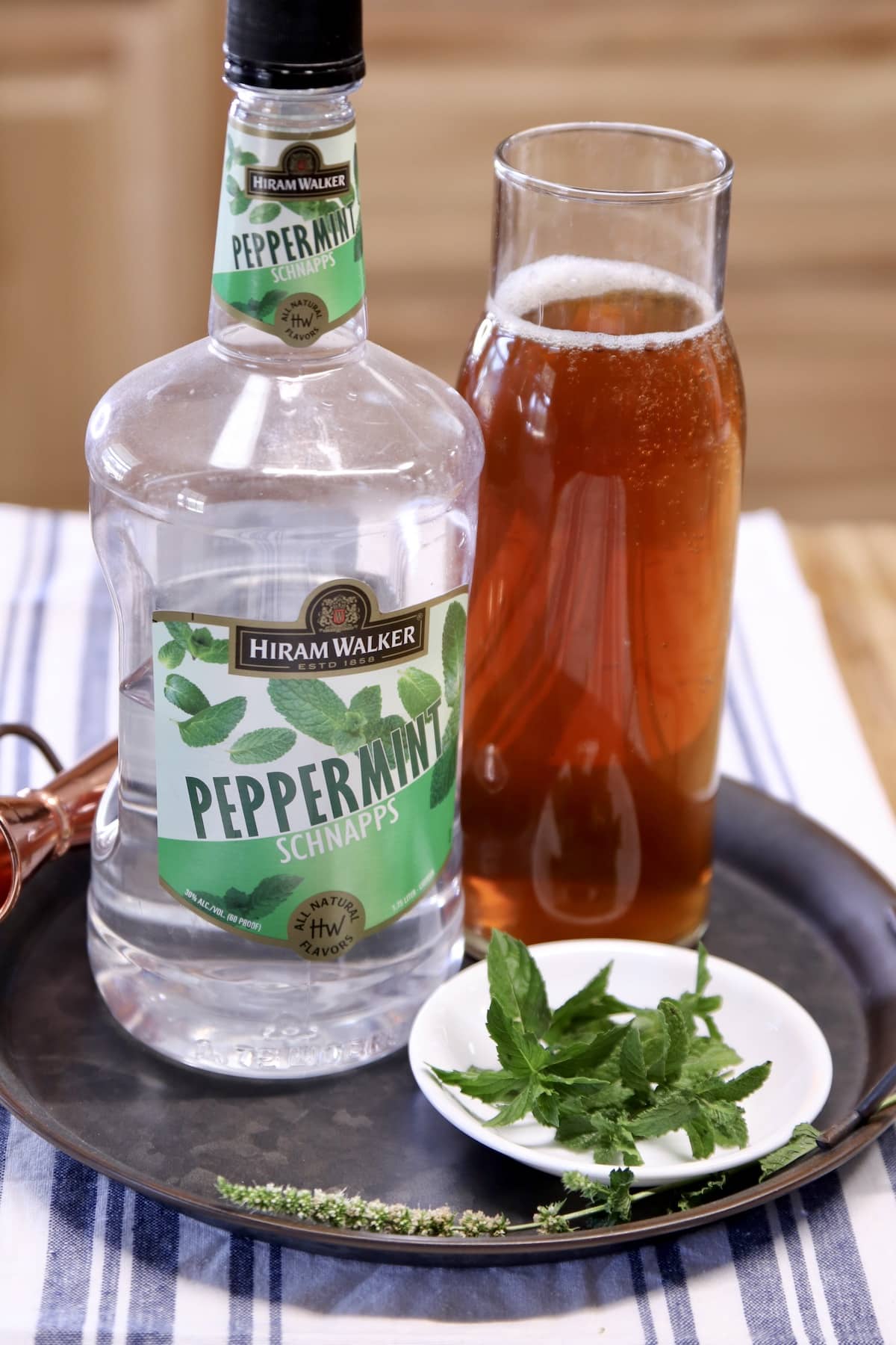 Sweet tea & peppermint schnapps on a tray for spiked iced tea cocktail.