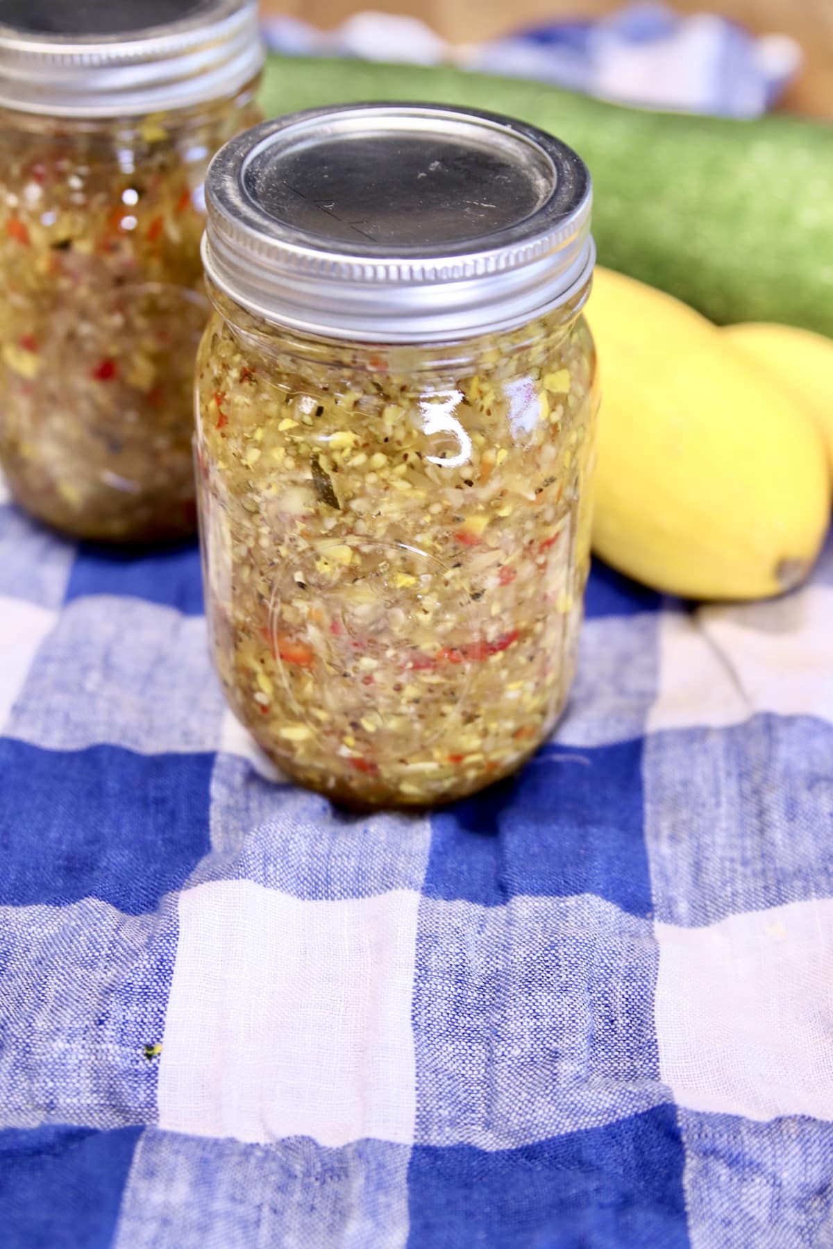Jars of squash relish with yellow squash and zucchini.