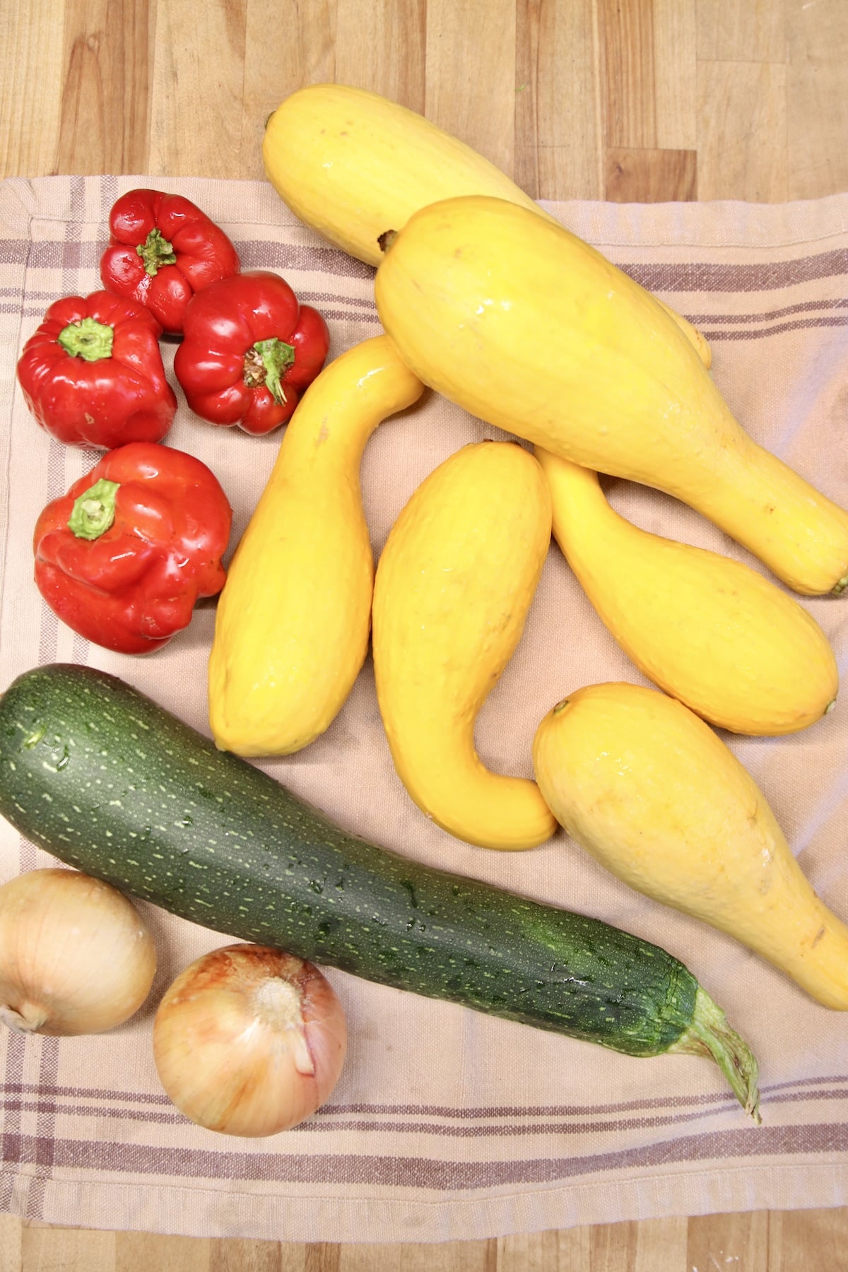 Onions, yellow squash, zucchini and red bell peppers.