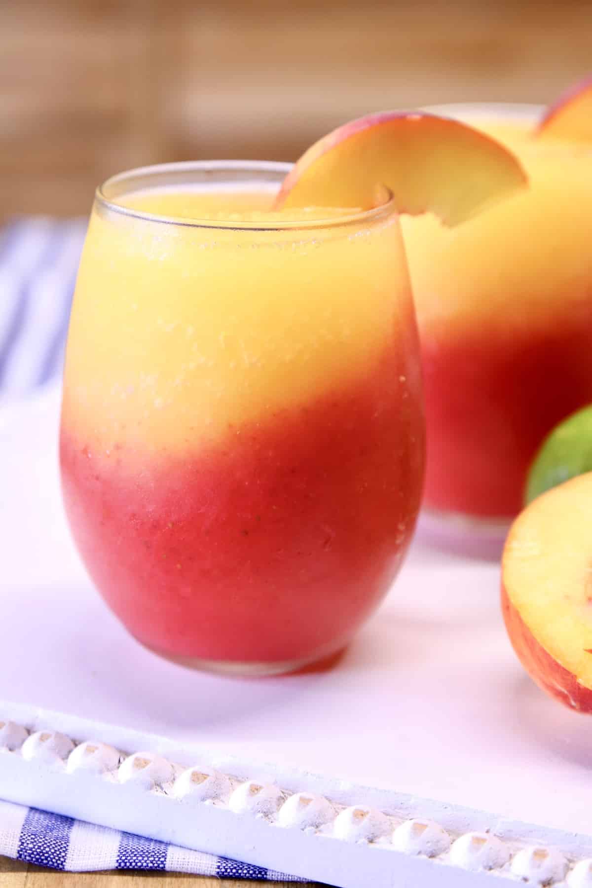 Strawberry Peach Daiquiri cocktails in stemless wine glasses.