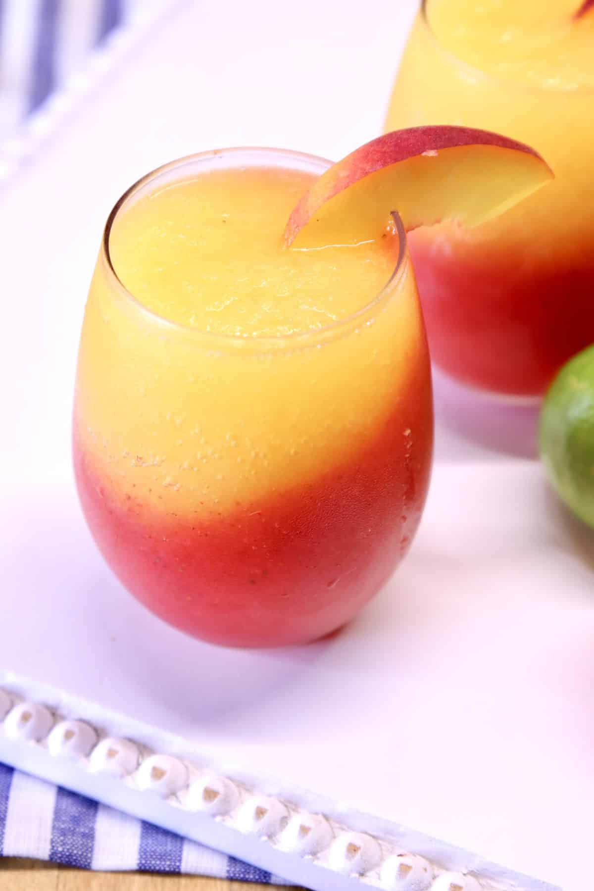 Stemless wine glasses with frozen strawberry peach daiquiris.