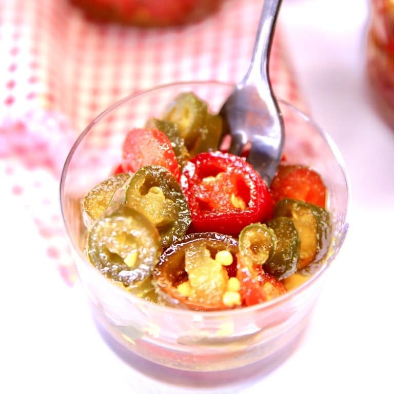 Candied jalapenos in a small jar.