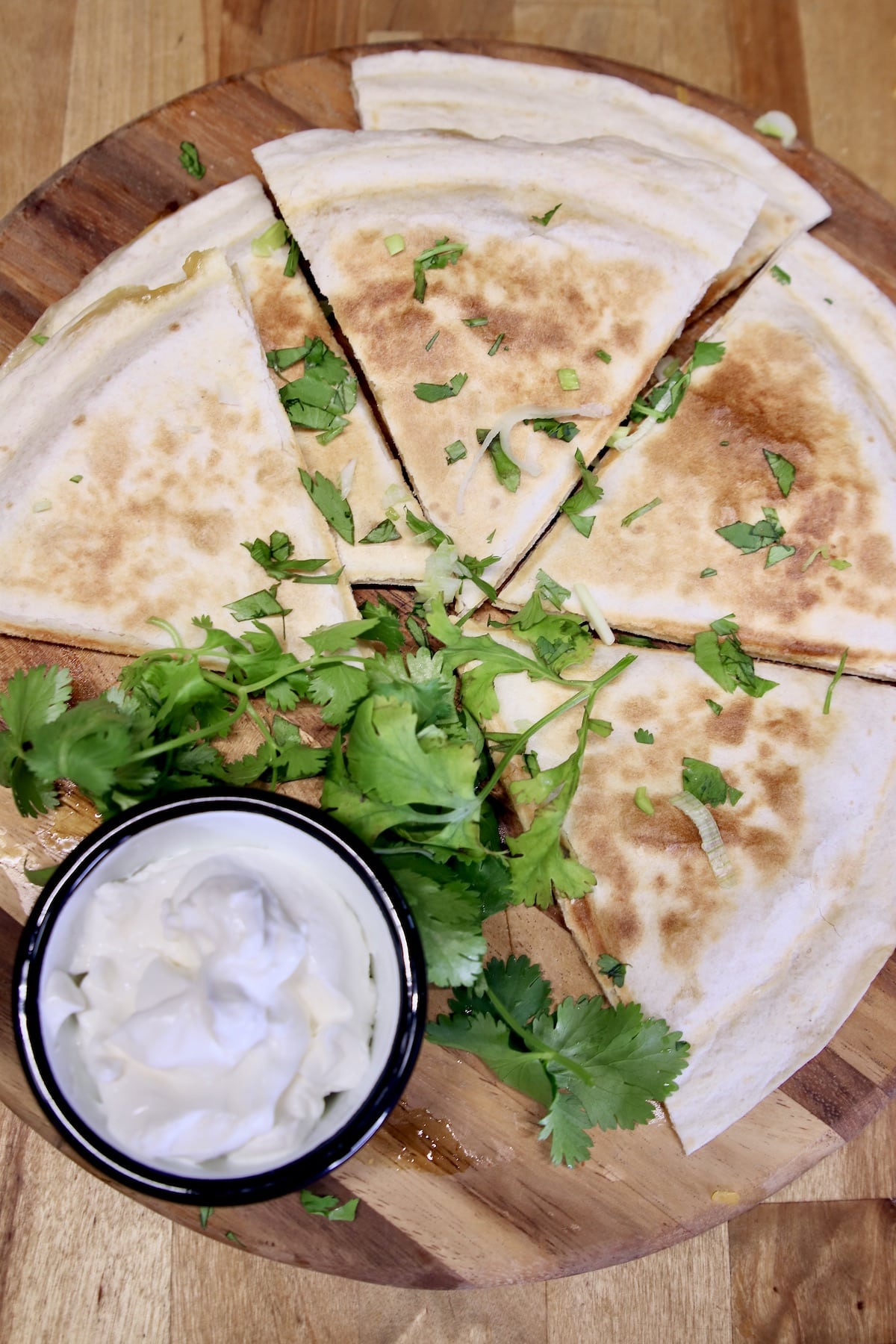 Chicken quesadillas with sour cream and cilantro.