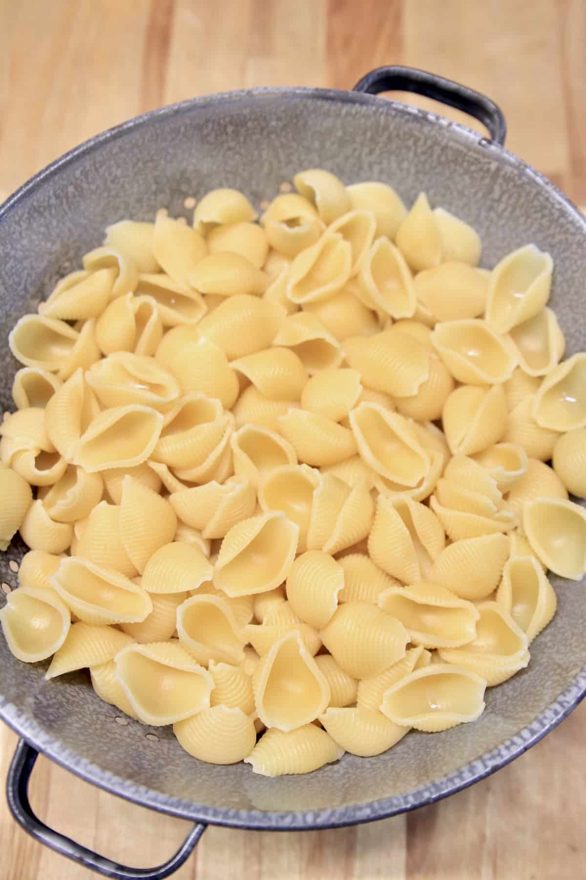 Pasta shells in a colander.