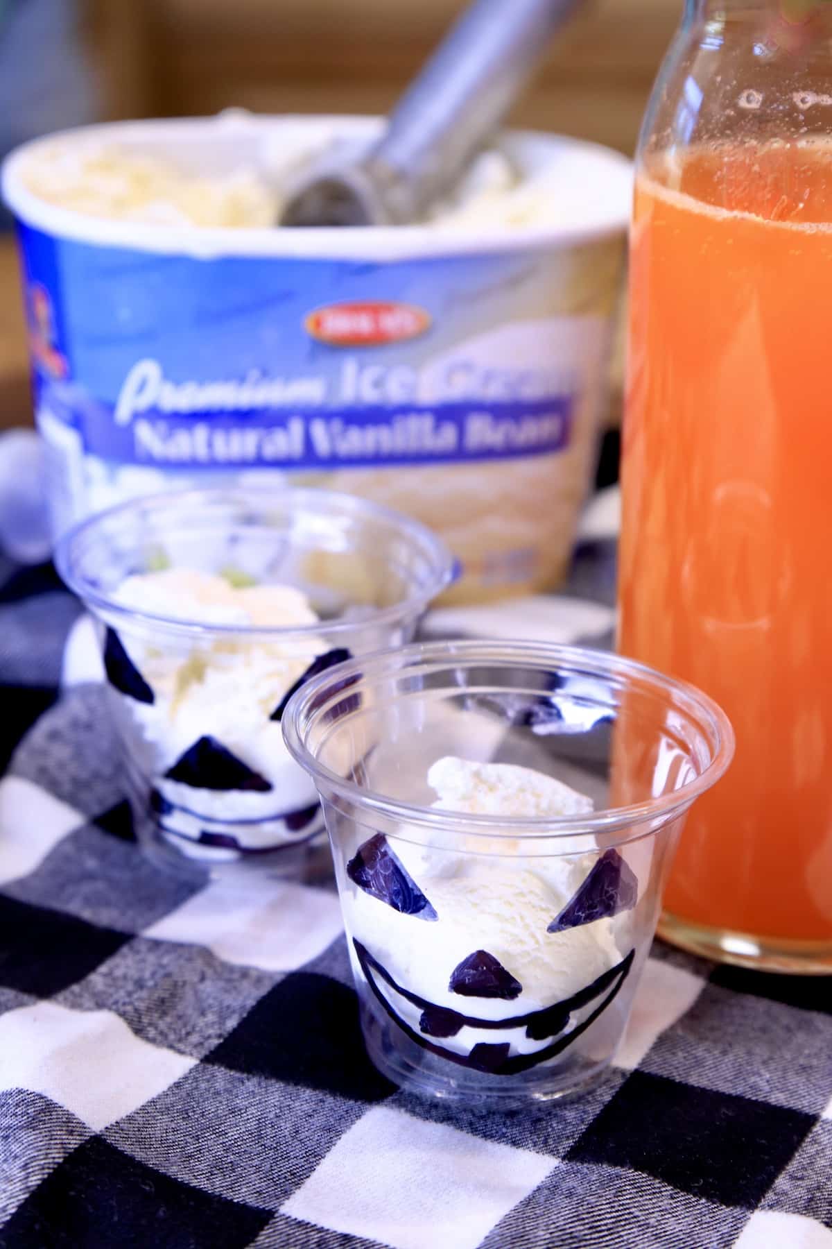Vanilla ice cream scooped into Halloween glasses.