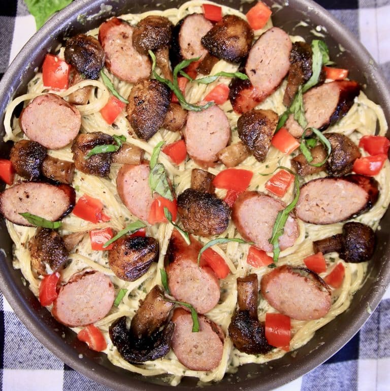 Pasta with smoked sausage and tomatoes.