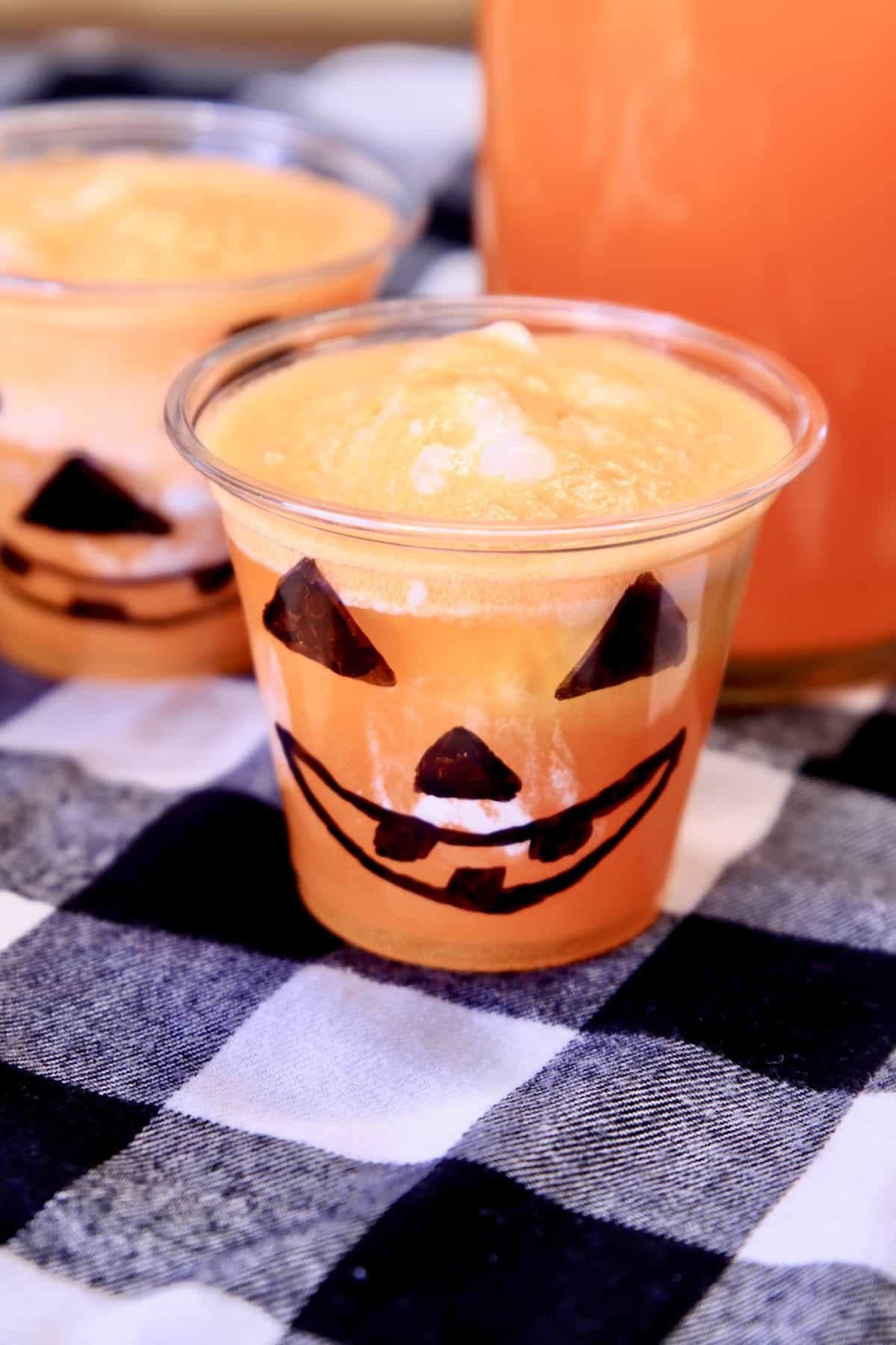 Jack-O-Latern glass with vanilla ice cream and orange punch.