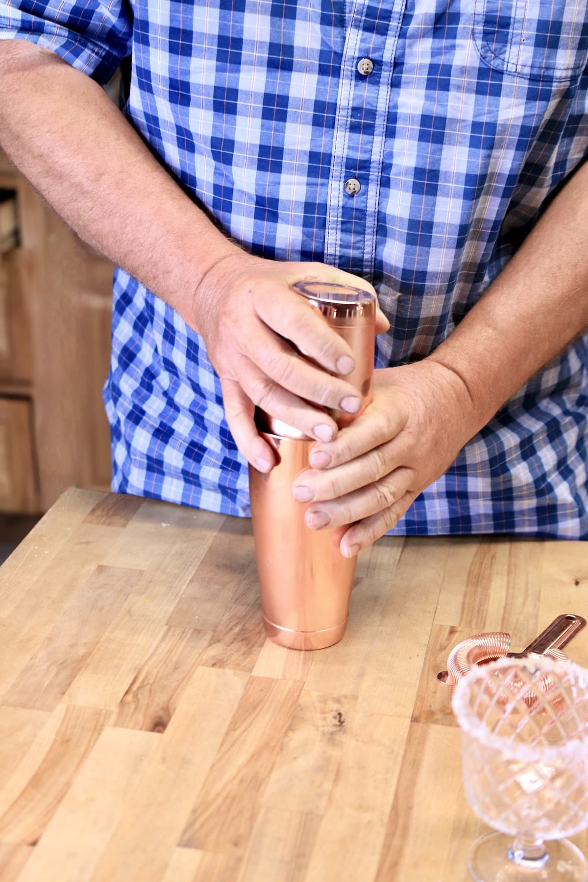 Man holding cocktail shaker.