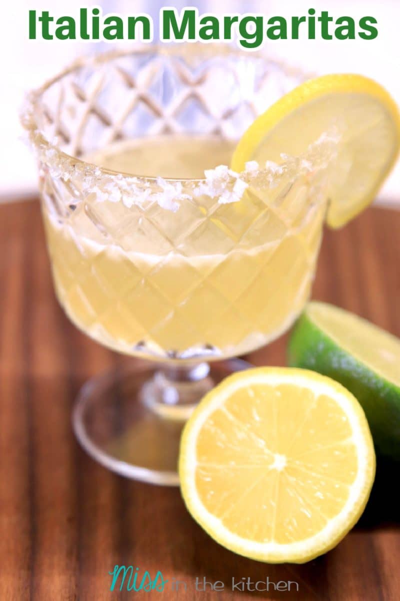 Italian Margarita in a glass on a dark board. Text overlay.