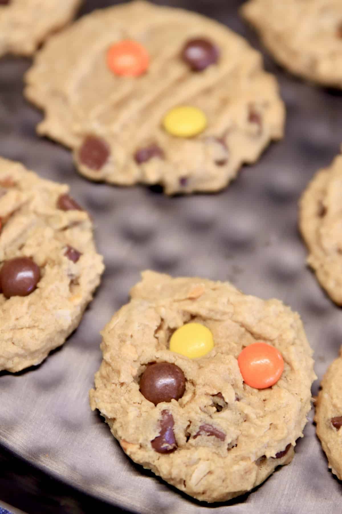 Closeup of tray of monster cookies with Reese's Pieces.