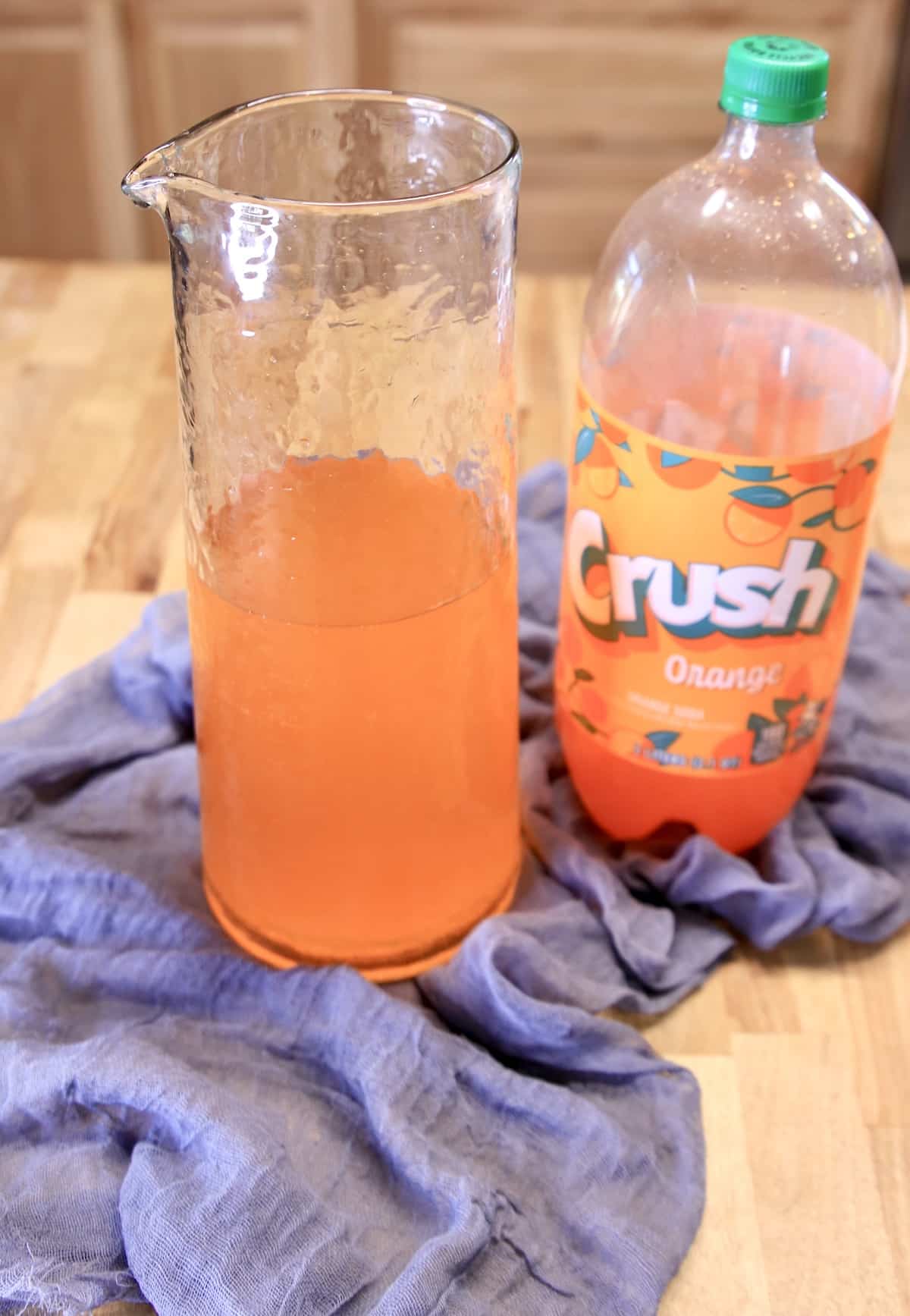 Pitcher with orange crush soda.