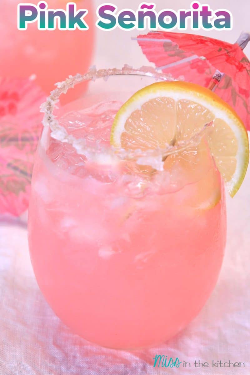 Pink Señorita Cocktail in a stemless wine glass. Closeup with text overlay.