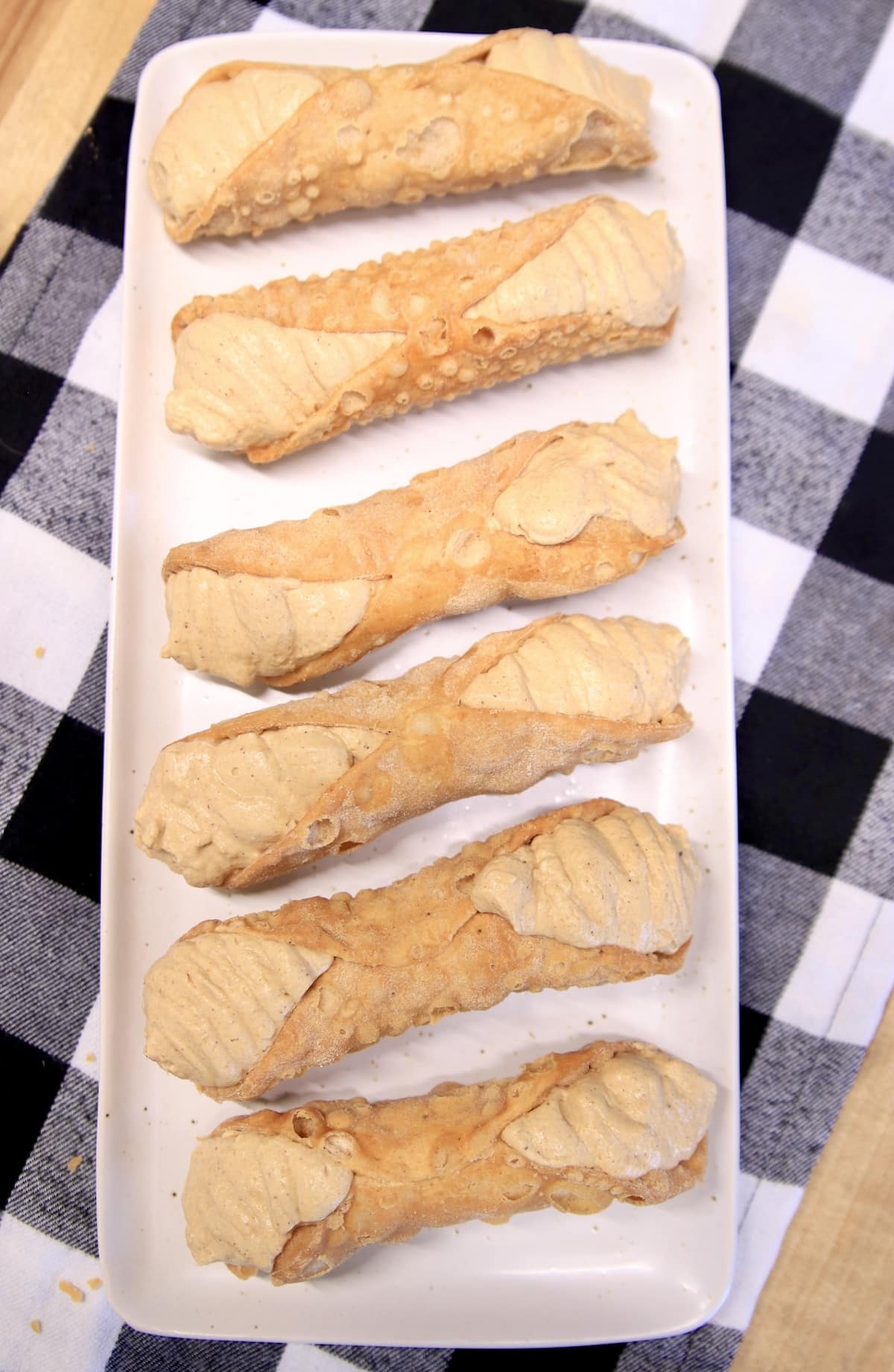 Pumpkin filled cannoli shells on a platter.