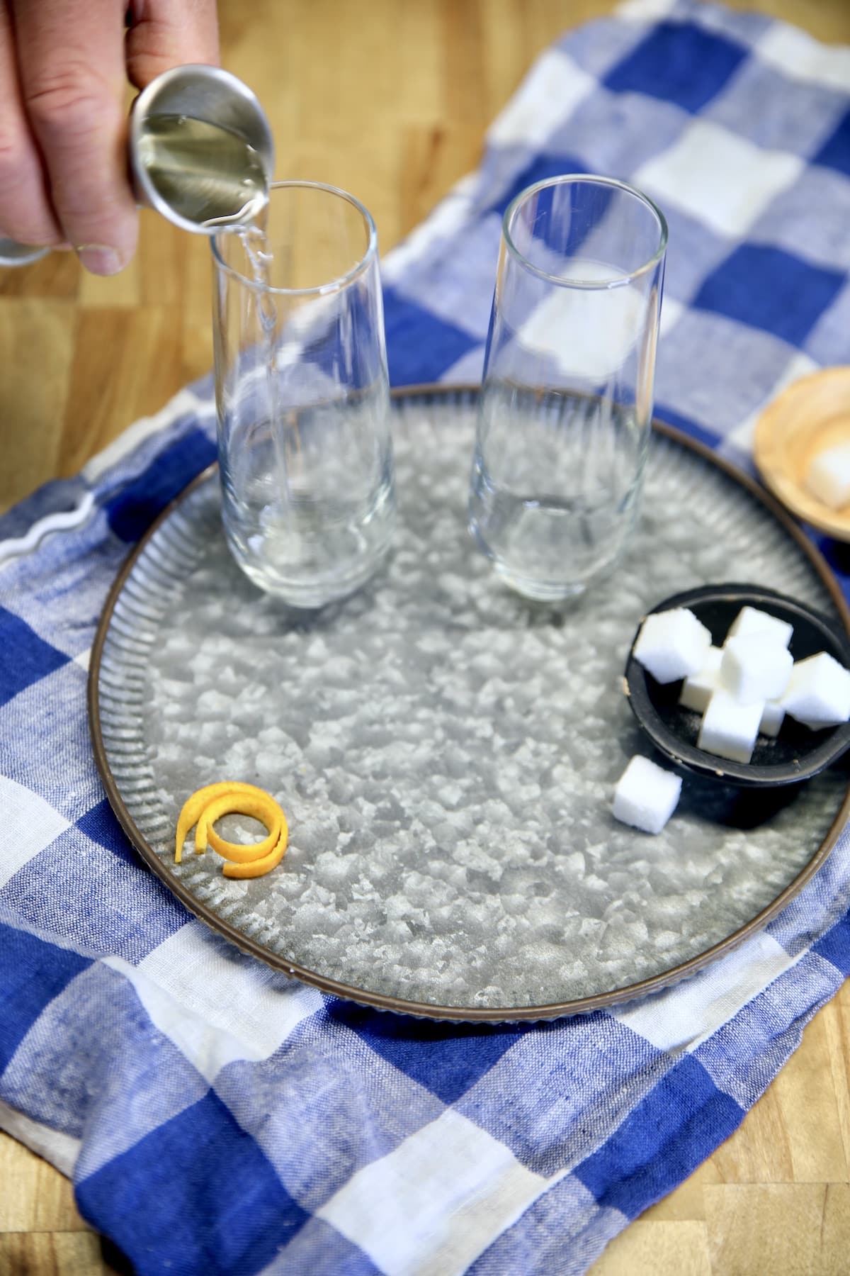 Adding vermouth into a cocktail glass.