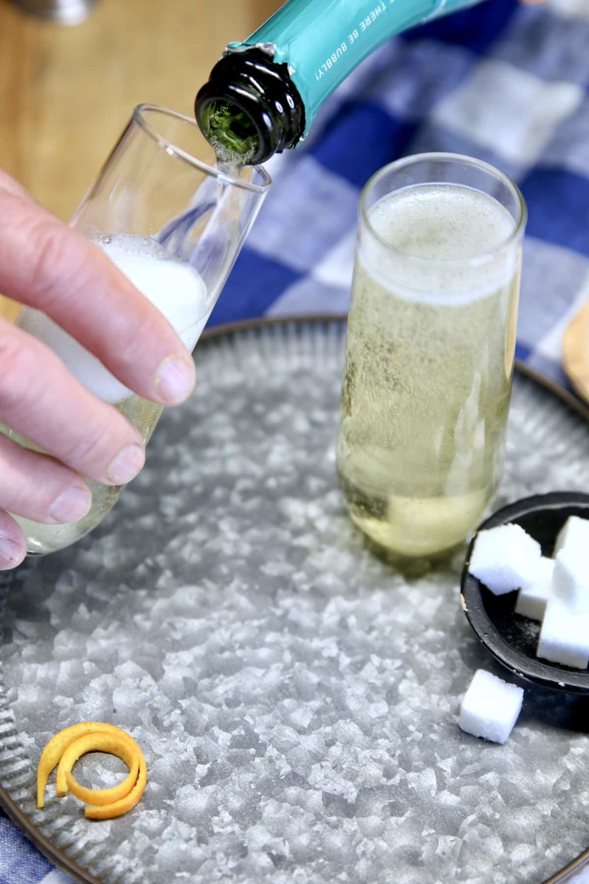 Filling champagne flutes.