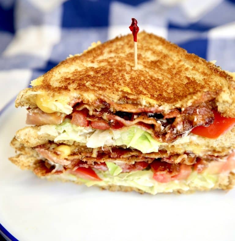 BLT Grilled Cheese Sandwich, cut in half, stacked.