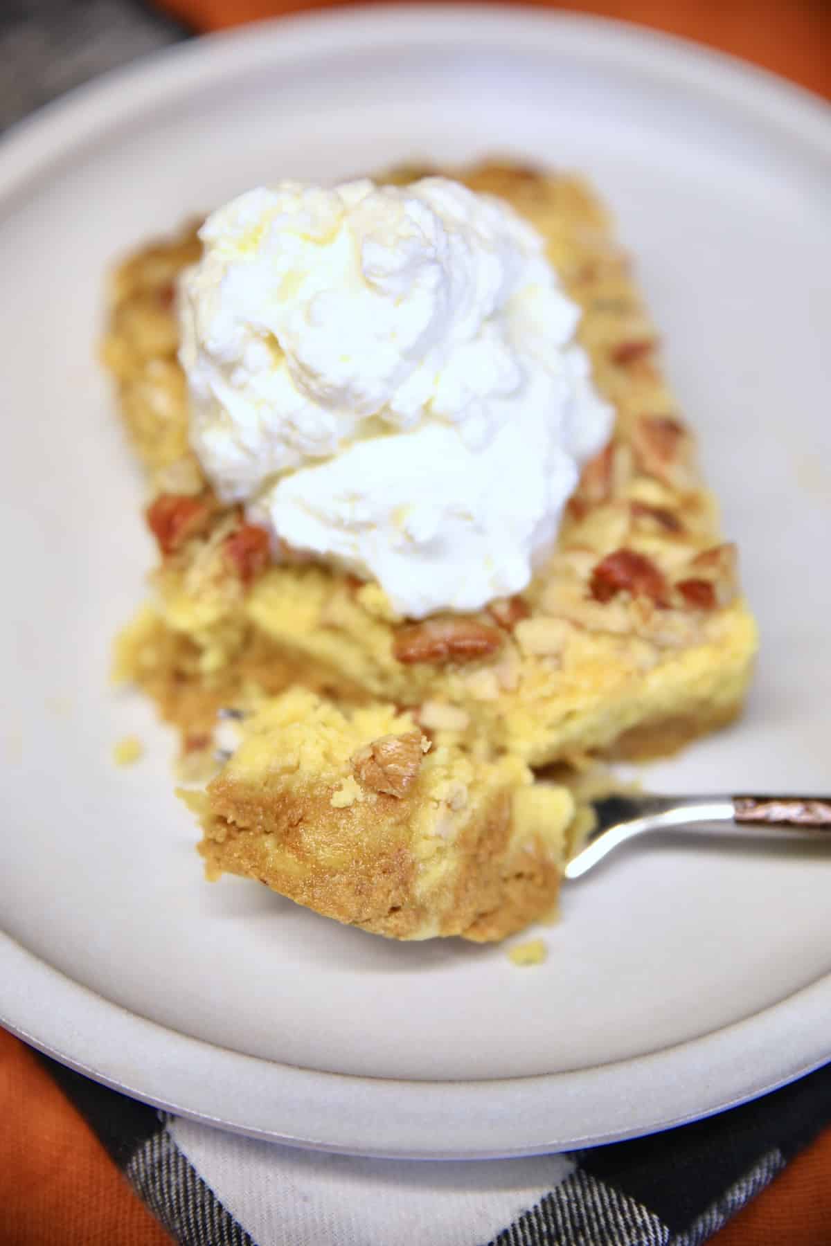 Overhead view of pumpkin pie cake with whipped cream.