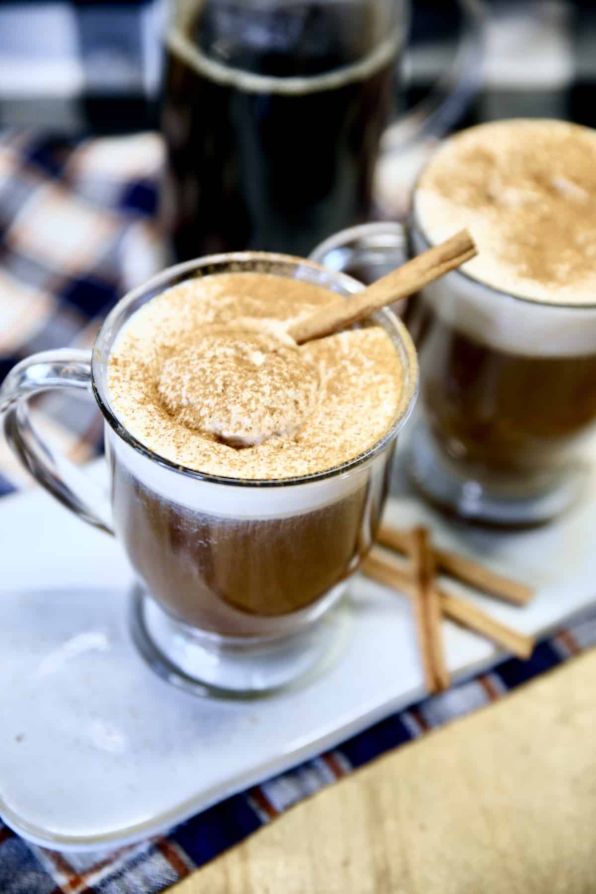 Pumpkin Spice Irish Coffee with cinnamon stick garnish.