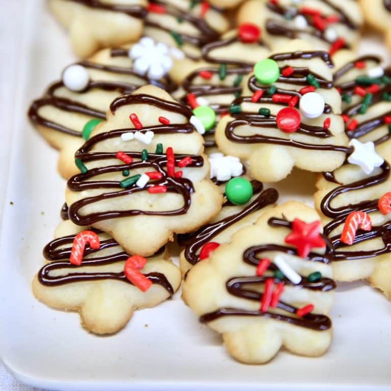 Spritz cookies with chocolate drizzle and sprinkles.