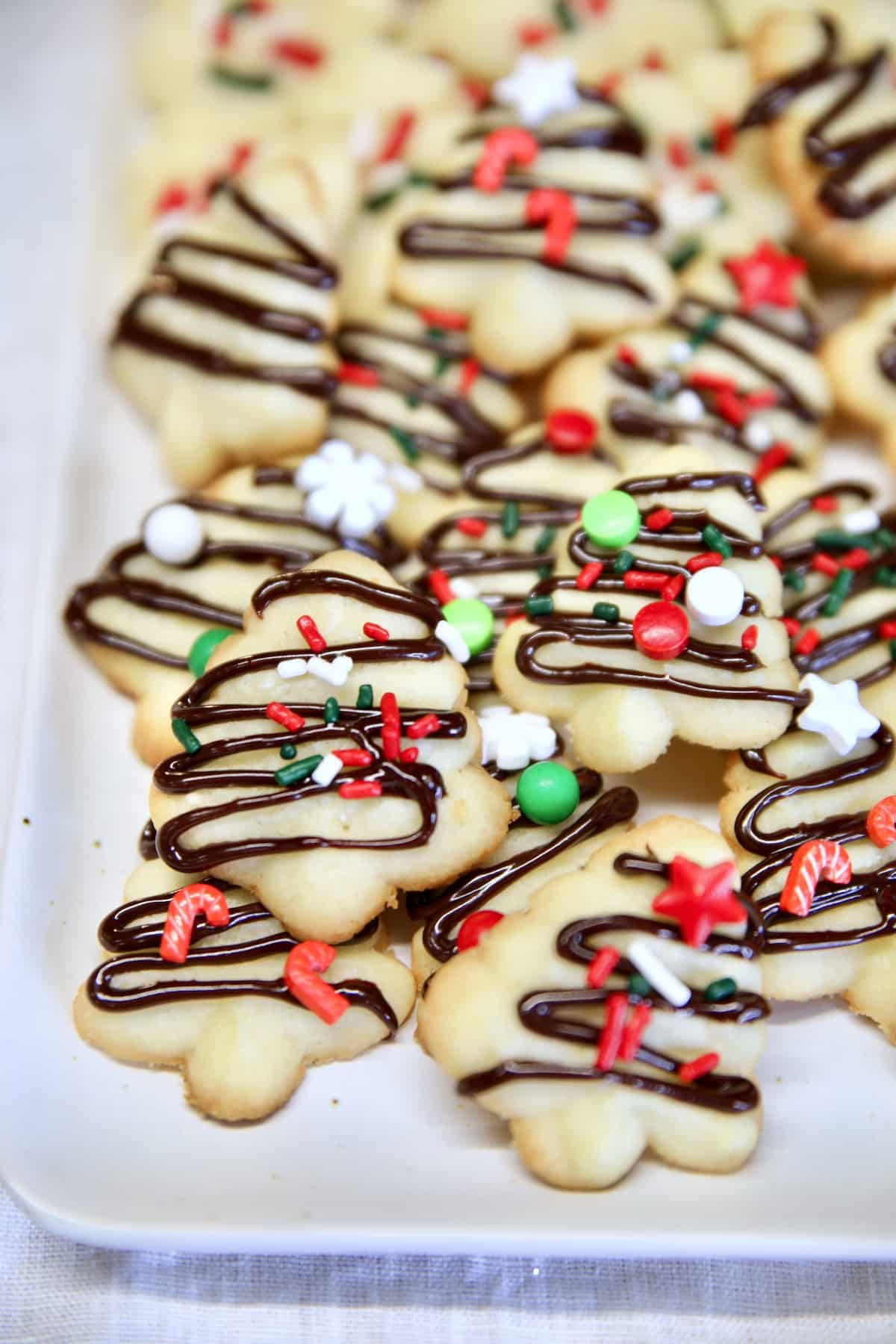 Close up of tray of spritz cookies with sprinkles.