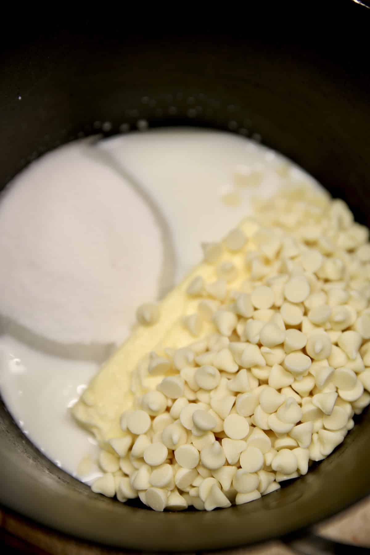 Pan with white chocolate chips, sugar, milk, butter.