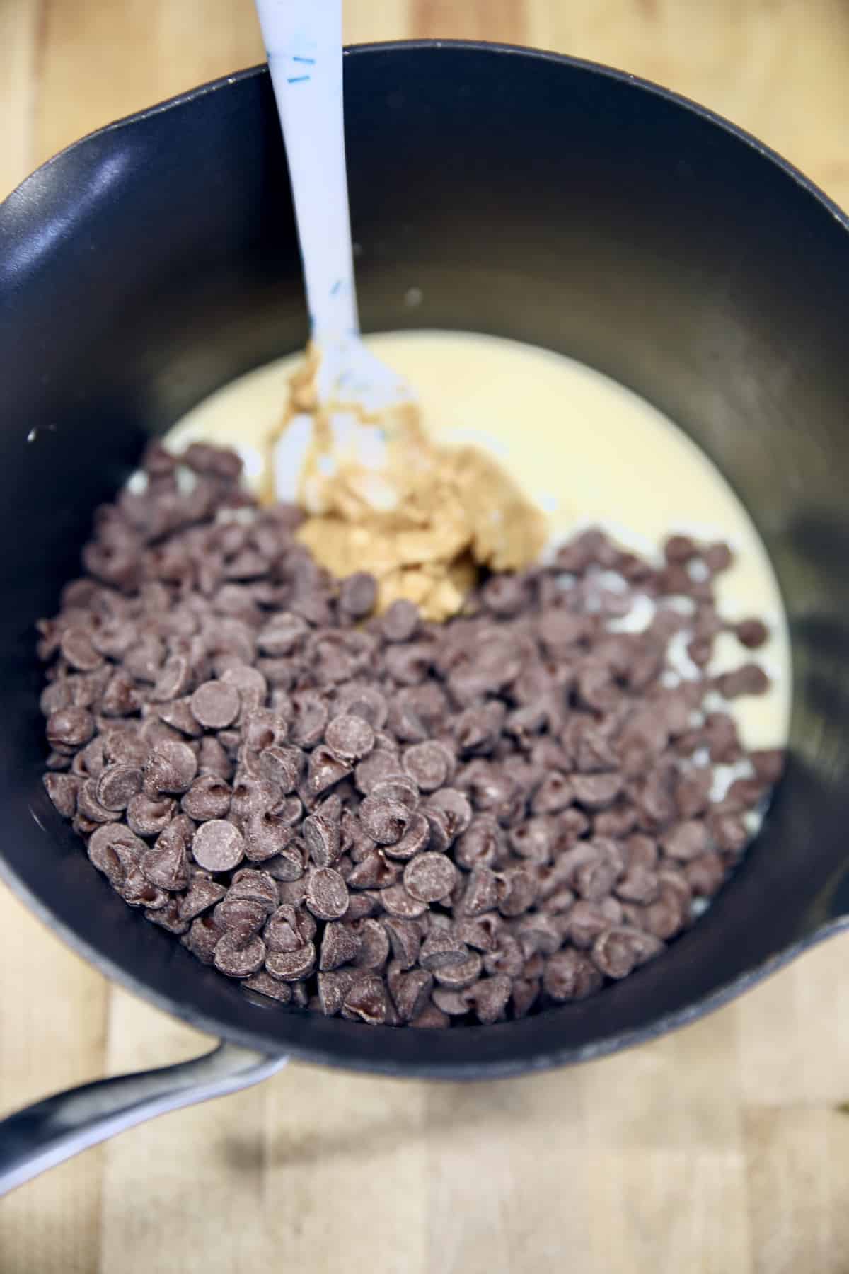 Pan with chocolate chips, peanut butter and sweetened condensed milk.