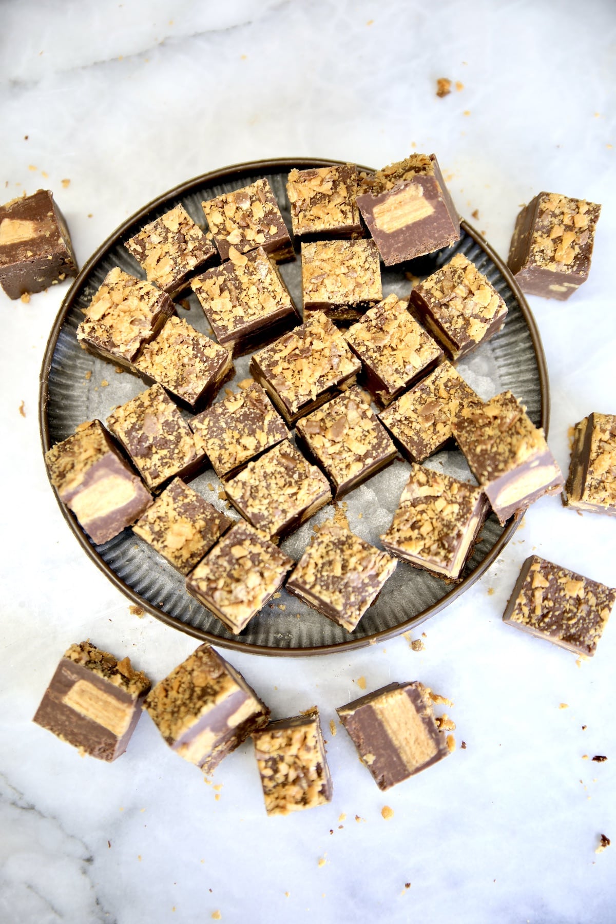 Fudge slices on a plate and marble board.