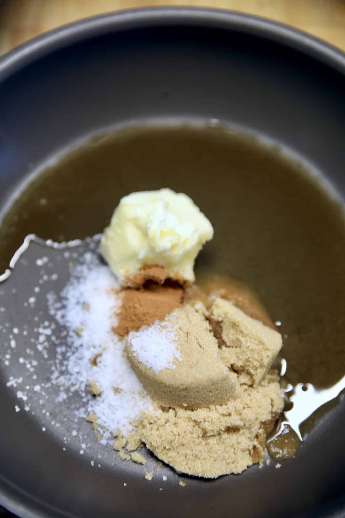 Pan of butter, brown sugar, rum, salt, cinnamon.