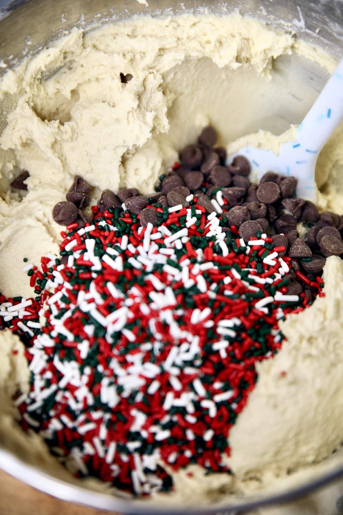 Cookie dough in a bowl, chocolate chips & sprinkles, not mixed in.