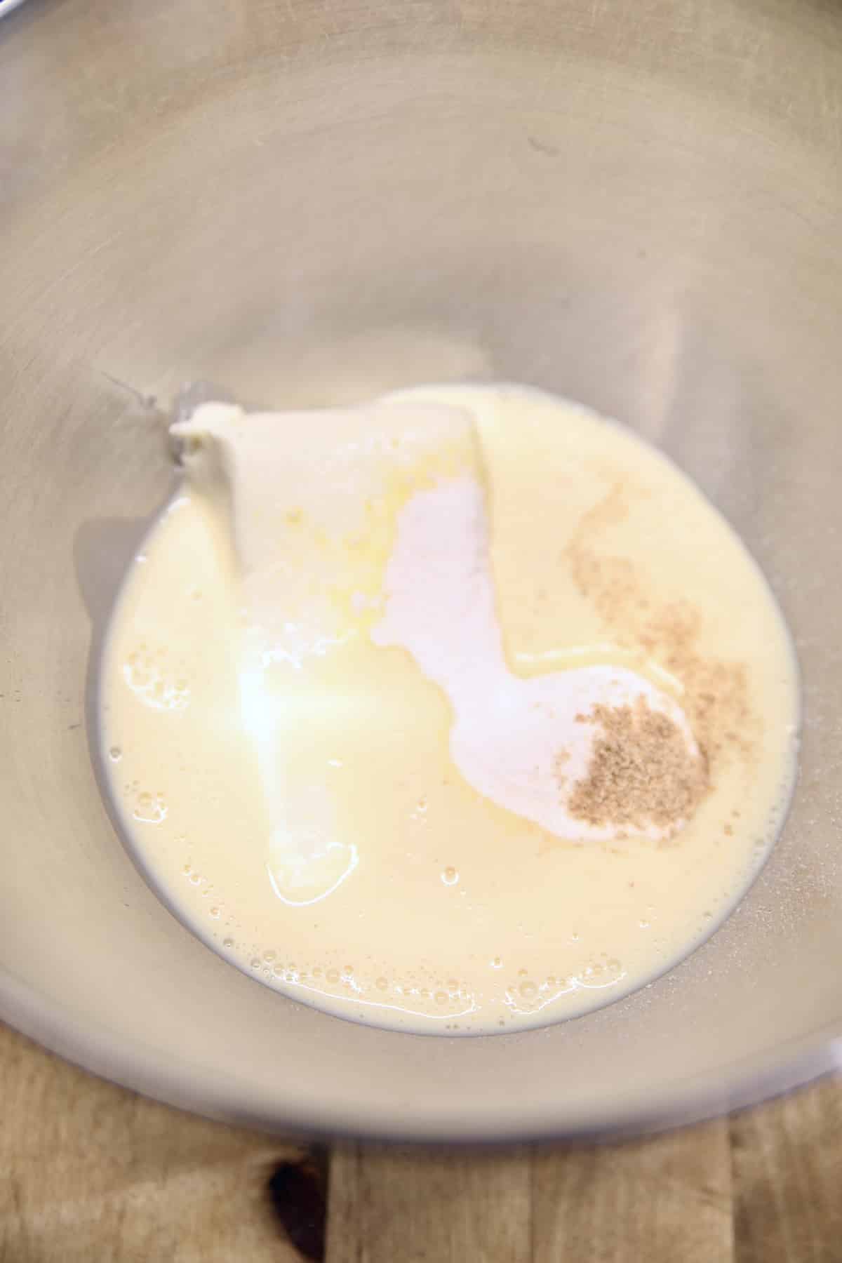 Bowl with cream cheese, eggnog, instant pudding and nutmeg.