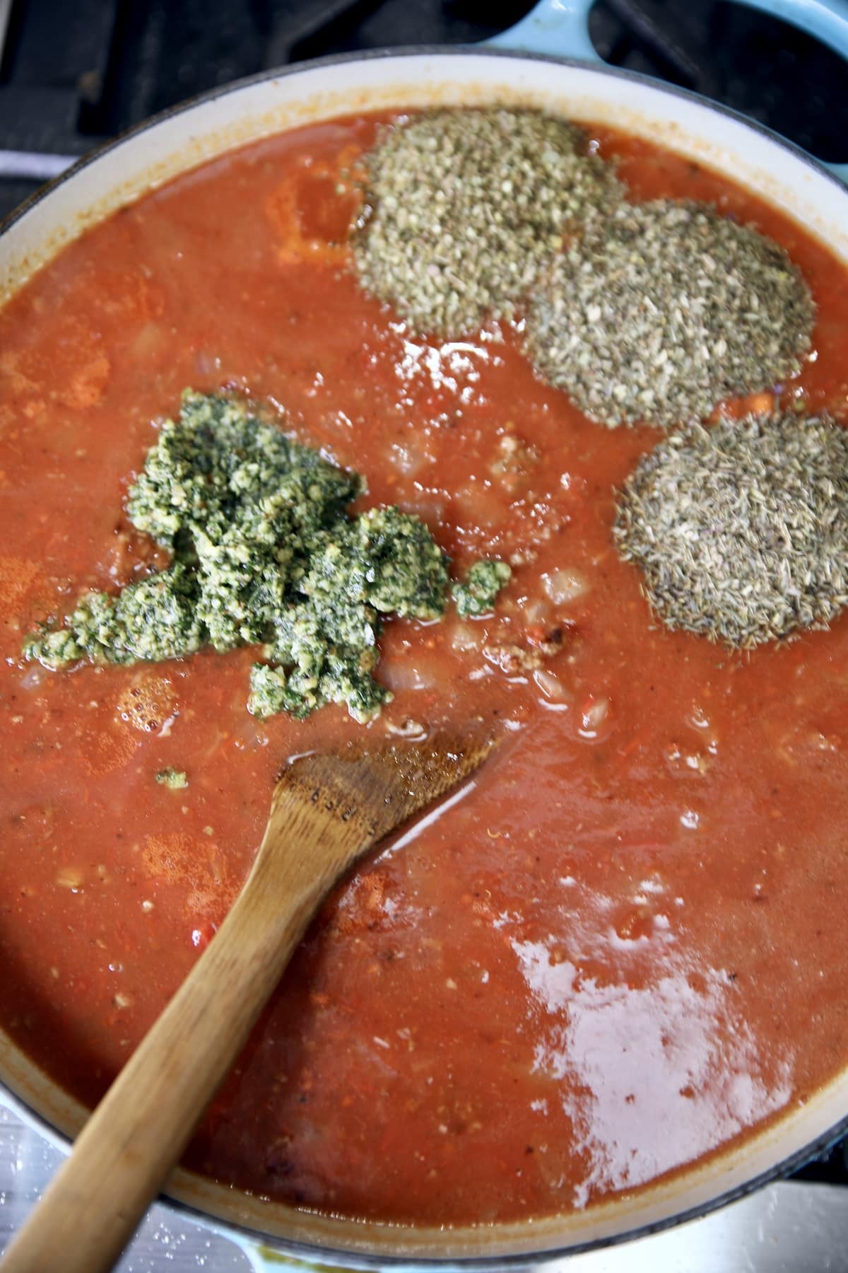 Tomato broth with pesto, spices.