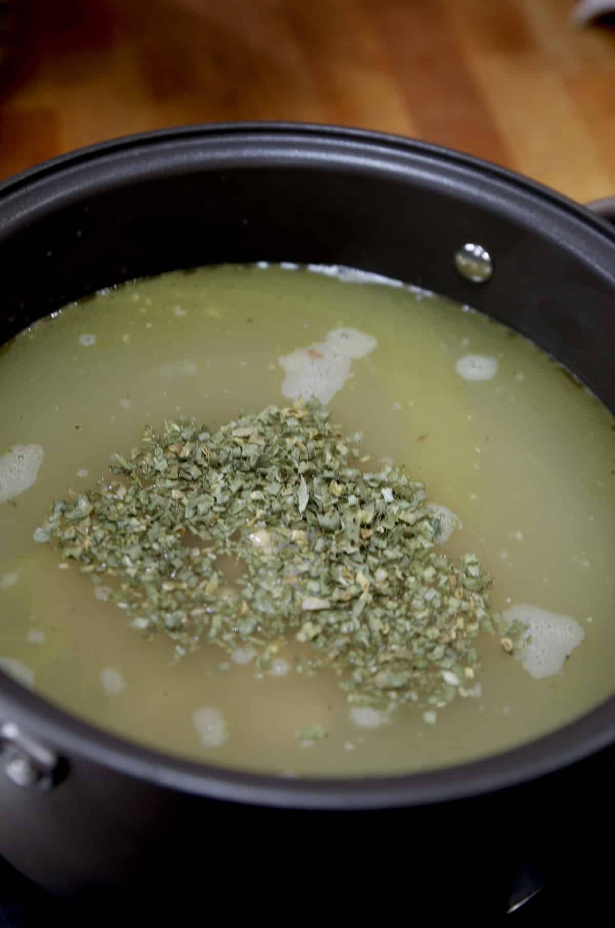 Chives in chicken soup pan.