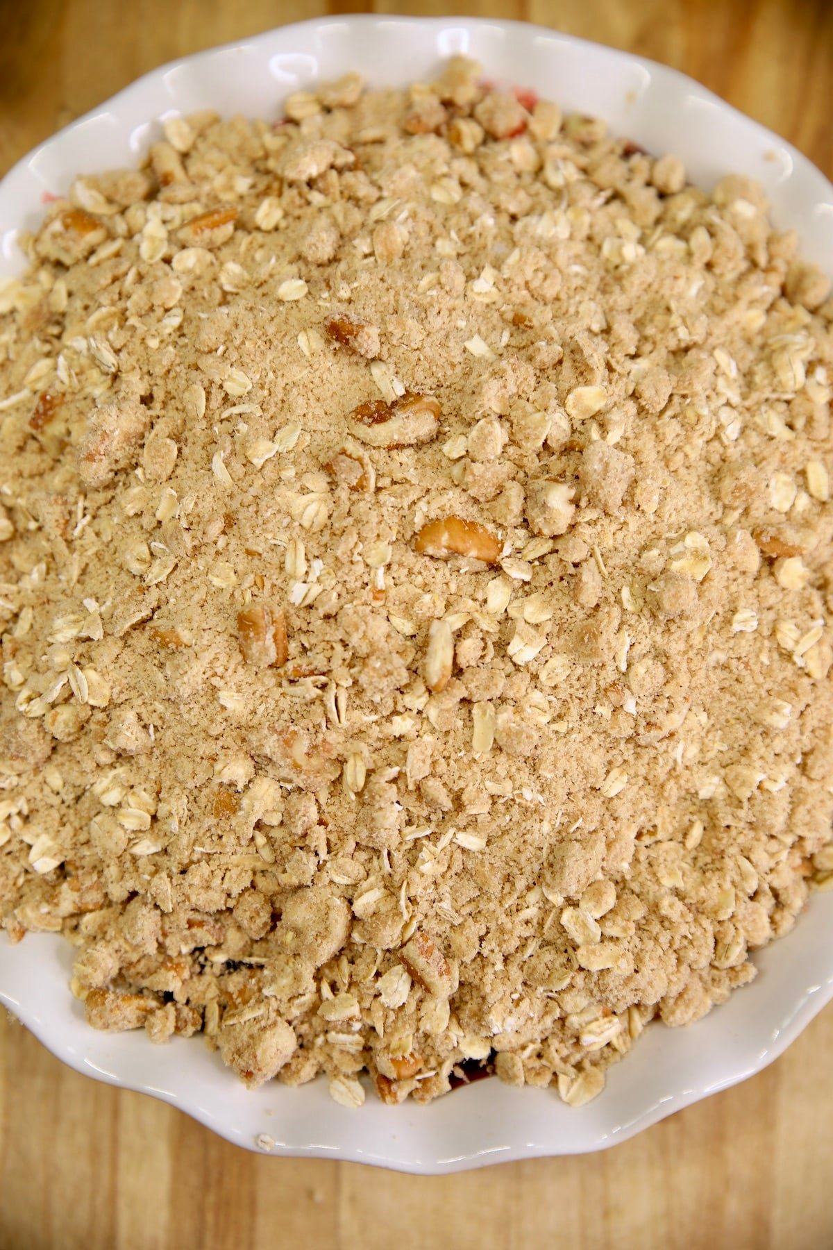 Pie plate with cherry crisp, ready to bake.