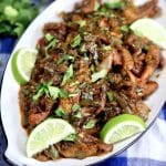 Chicken fajitas on a platter.